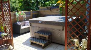 a outdoor kitchen with a counter and two benches at Nuit etoile et jacuzzi prive in Pleuven