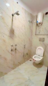 a bathroom with a toilet and a shower at SUNRISE Near Lucknow Airport in Lucknow