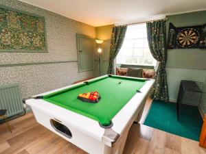 a room with a pool table in a living room at Boundcliffe Farm in Allerston