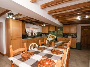 a kitchen with a long table with chairs and a tableasteryasteryasteryasteryastery at Boundcliffe Farm in Allerston