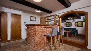 a bar with chairs and a brick wall at Villa 77 by Villas Guide in Sisak
