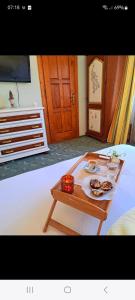 a coffee table with food on top of a bed at Pension Paunasul in Buşteni