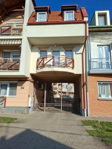 a building with a gate in front of it at GINGER apartman in Hajdúszoboszló