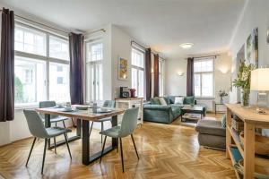 a living room with a table and chairs and a couch at Villa Benedikt in Bad Gastein