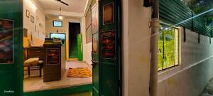 an entrance to a room with a green door at Art Bliss Rishikesh - Yoga Hostel & Café in Rishīkesh