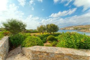 a view of a river from a stone wall at Beachfront Majestic Villa in Liaropá