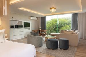 a bedroom with a bed and a living room at Views Boutique Hotel & Spa in Wilderness