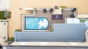 a building with a blue wall with a tv on it at Taplow House Hotel & Spa in Maidenhead +5 photos