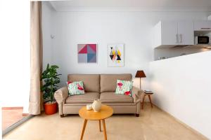 a living room with a couch and a table at Fuente de la Duquesa in Manilva
