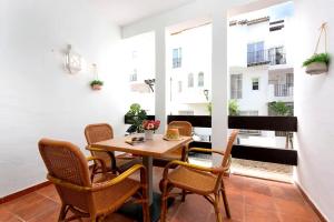 a room with a table and chairs and a balcony at Fuente de la Duquesa in Manilva