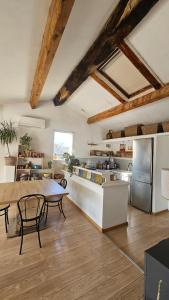 a large kitchen with a table and a counter top at Appartement typique in Pertuis +7 photos