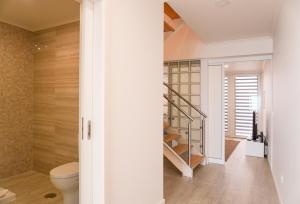 a bathroom with a toilet and a staircase at South Shore 1 - Jacuzzi - HOST & CHILL in São Roque +55 photos