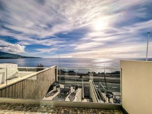 a balcony with chairs and a view of the water at South Shore 1 - Jacuzzi - HOST & CHILL in São Roque