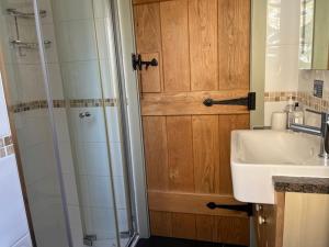 a bathroom with a sink and a shower at Pear Tree Barn - Amazing Country views - Pet friendly - Balcony in Newquay +14 photos