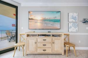 a living room with a tv on a wall at Phoenix X 506 condo in Orange Beach +55 photos