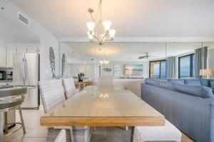a living room with a table and a couch at Phoenix X 506 condo in Orange Beach