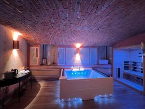 a large kitchen with a tub in the middle of a room at Emme Loft I Sweet Moon - Exclusive Loft & Private Spa Milan in Milan