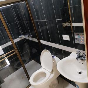 a bathroom with a toilet and a sink at Hotel Laureles Park in Medellín +45 photos