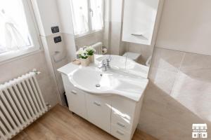 a white bathroom with a sink and a mirror at CASA MIA by Design Studio in Colico +20 photos