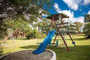 a playground with a blue slide in a park at Véio Chico’s Ranch | Swimming Pool | Barbecue in Ibiúna