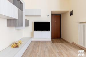 a living room with a flat screen tv on a wall at CASA MIA by Design Studio in Colico