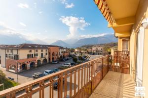 a balcony with a view of a street and mountains at CASA MIA by Design Studio in Colico