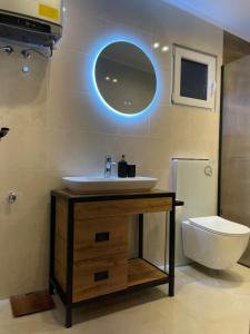 a bathroom with a sink and a toilet at Apartmani PARADISO in Čapljina +23 photos