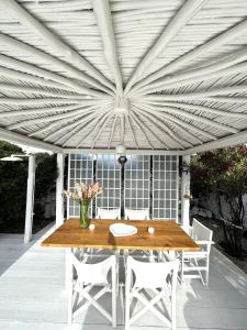 a wooden table and chairs on a patio at Windmill of Mykonos in Mikonos