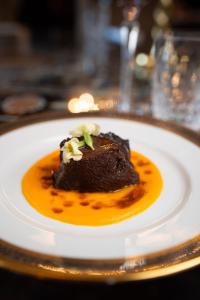 a piece of chocolate dessert on a plate on a table at Castello di Casalborgone, Luxury Italian Castle Hotel in Casalborgone