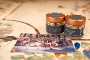 two jars of paint sitting on top of a book at Castello di Casalborgone, Luxury Italian Castle Hotel in Casalborgone +165 photos