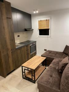 a living room with a couch and a table at Apartmani PARADISO in Čapljina