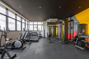 a gym with several treadmills and machines in a room at Ibiza 2410 · Vista incrível: Piscina, Academia e Bem Localizado in Curitiba