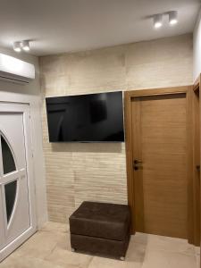 a room with a flat screen tv on a wall at Apartmani PARADISO in Čapljina