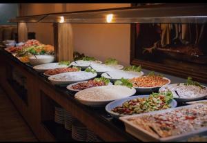 a buffet with many plates of food on a table at Yalçın Resort Hotel in Korgan
