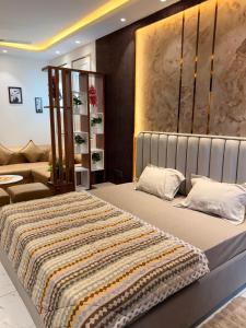a bedroom with a large bed and a couch at PATEL Residency in Ghaziabad