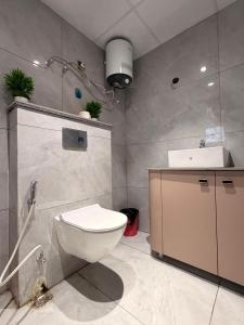 a bathroom with a toilet and a sink at PATEL Residency in Ghaziabad