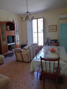 a living room with a table and a couch at Casa Abenante in Corigliano Calabro