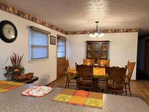 a dining room with a table and a clock on the wall at Diamond Retreat in Sweeden