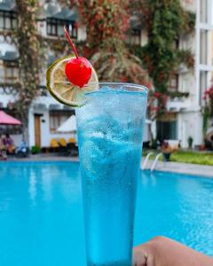 a drink with a lemon slice and a cherry at Hotel Sol de Ica in Ica