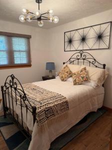 a bedroom with a bed and a chandelier at Diamond Retreat in Sweeden