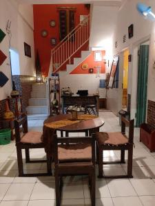 a room with a table and chairs and a staircase at Edotel Tebe Syariah in Rampal