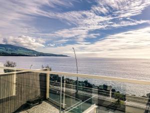 a balcony with a view of the water at South Shore 2 - Jacuzzi - HOST & CHILL in São Roque
