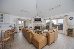 a living room with a couch and a fireplace at 1067 - Easy Street in Corolla