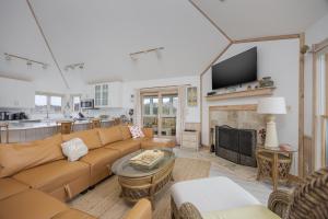 a living room with a couch and a fireplace at 1067 - Easy Street in Corolla