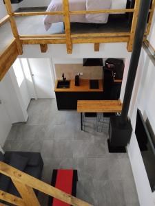 a loft room with a bed and a table at Apartamento Catalina in Algodonales