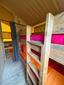 a room with two bunk beds in a cabin at Càmping Parc Gualba in gualba de Dalt