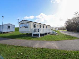 a tiny house on the side of a road at Dunes View in Prestatyn