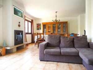a living room with a couch and a fireplace at Casa do Batoco in Vieira do Minho