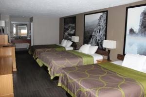 a hotel room with two beds and a television at Super 8 by Wyndham Fort Chiswell Wytheville Area in Max Meadows