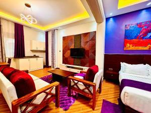 a room with a living room with a bed and a couch at Pieme Hotel Residence in Migade
